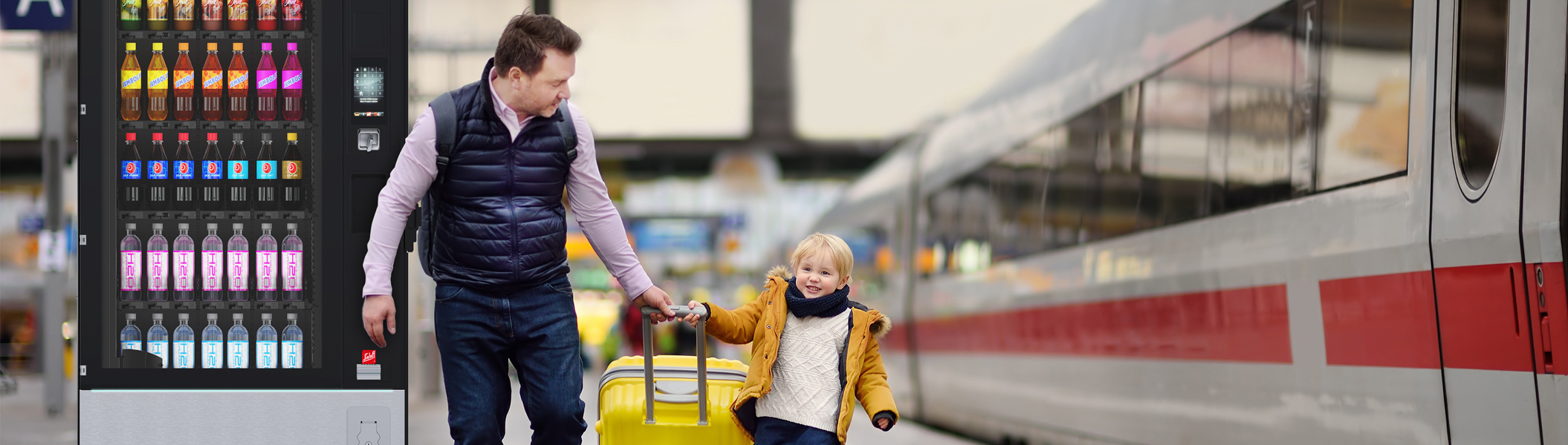Bahnhof Ein Mann mit Kind am Bahnhof neben einem Automaten