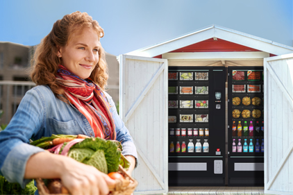 Hofladen Ein Automat als Hofladen mit einer Bäuerin im Vordergrund