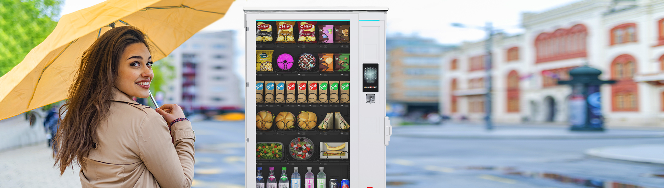 SiLine<sup>®</sup> Outdoor-Serie Frau mit gelbem Regenschirm vor einem Sielaff-Automaten aus der SiLine Outdoor-Serie