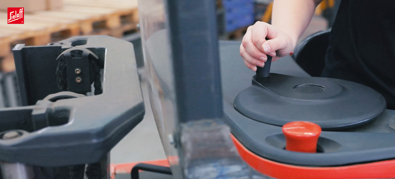 Eine Fachkraft für Lagerlogistik mit einem Hubwagen